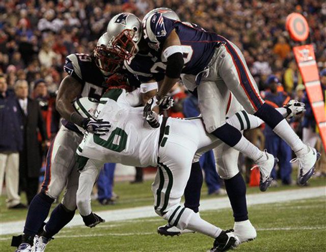 The Patriots' Gary Guyton and Leigh Bodden knock down Mark Sanchez